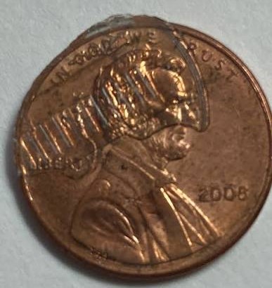 2008 penny brockage error showing mirror-image incuse impression of Lincoln portrait on the reverse side