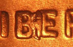 Close-up of 2008 penny BIE die crack error showing raised vertical mark between B and E in LIBERTY inscription